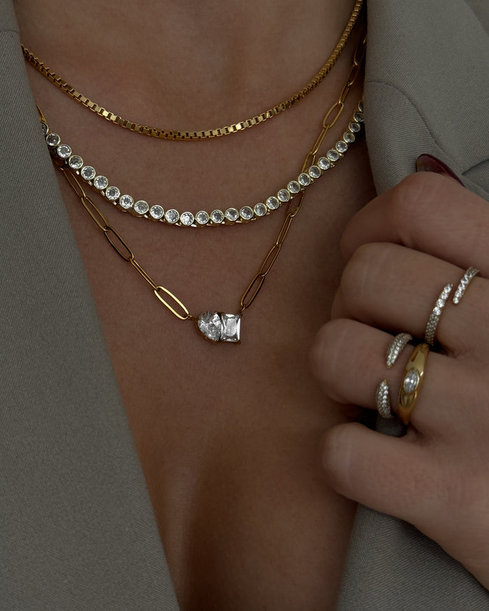 A model wearing the gold Heirloom bezel tennis necklace in a Beads by Tara campaign image