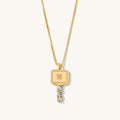 Close up of the gold Heirloom Key necklace on a white background