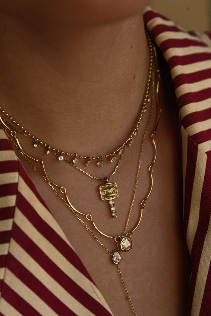 Gold Heirloom Key pendant necklace with crystal detailing along the key