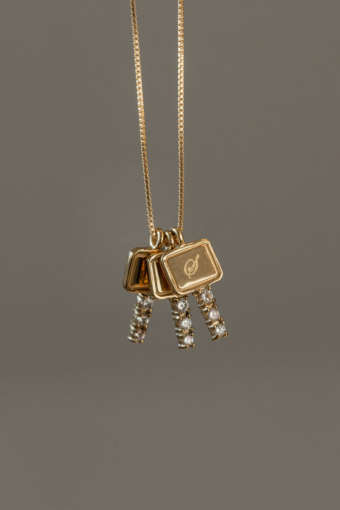 Sparkling gold key charm necklace that can be engraved with initials