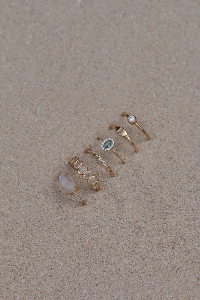 The Infinity Twist ring showing its interwoven gold band and pavé crystals