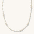 Close up of the gold and freshwater pearl Isla necklace on a white background
