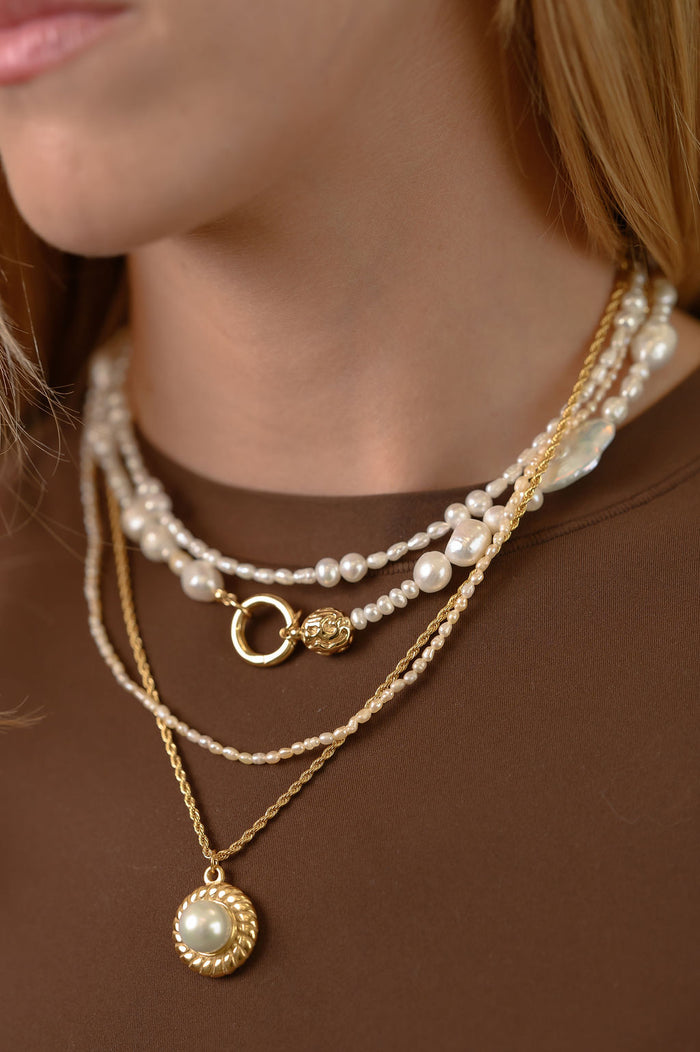 The gold and freshwater pearl Isla necklace from Beads by Tara, shown on a white background