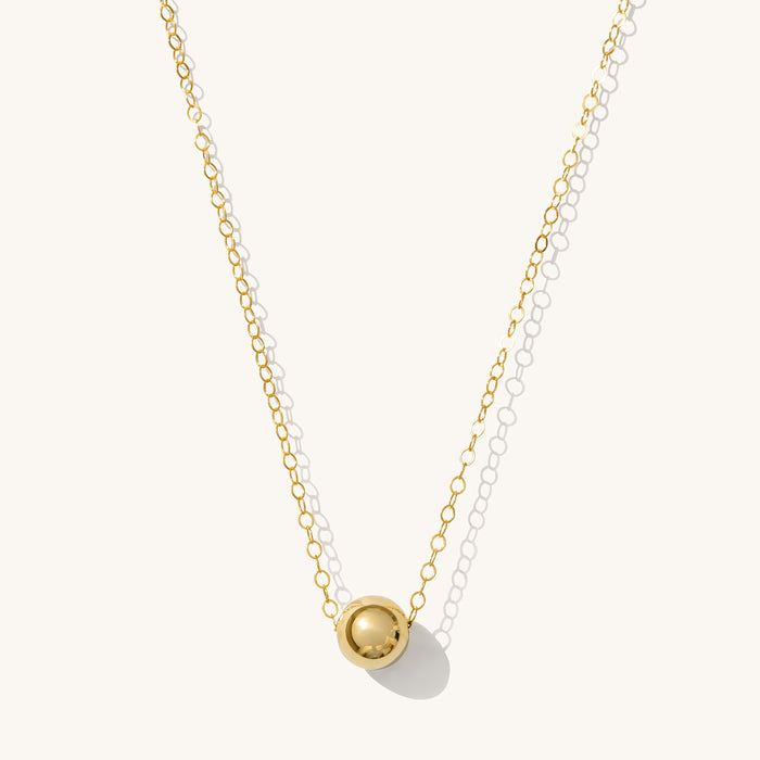 Jackie necklace, a single gold bead on a dainty adjustable chain
