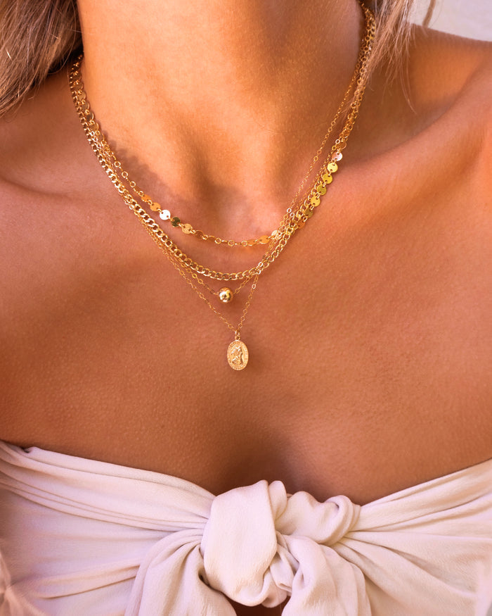 Gold Jackie bead necklace layered with dainty gold chains