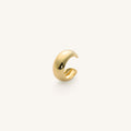Close up of gold ear cuff on white background