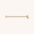 Close up of a gold jewelry extender on a white background