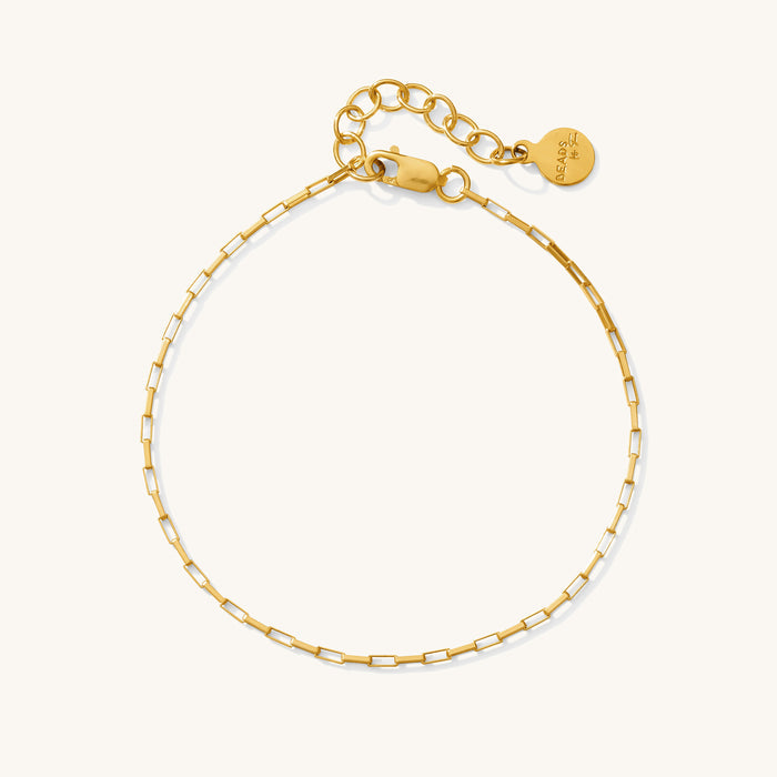 Close up of the gold Joy square link anklet on a white background