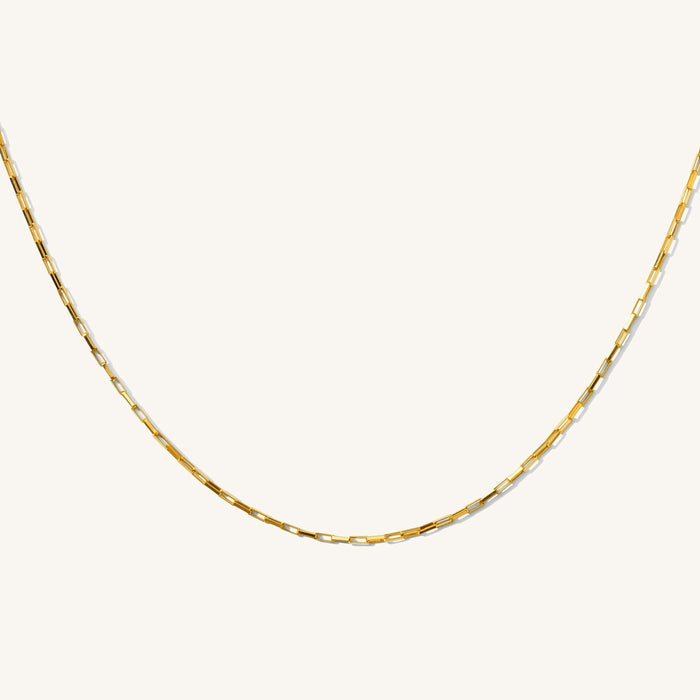 Close up of the gold Joy square link necklace on a white background