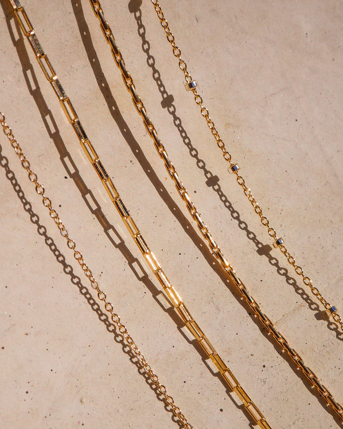 The gold-filled Joy necklace, a mini square link chain built for everyday wear