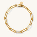 Close up of an oversized gold link bracelet on a white background