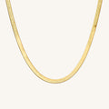 Close up of the gold Jumbo Nile herringbone necklace on a white background