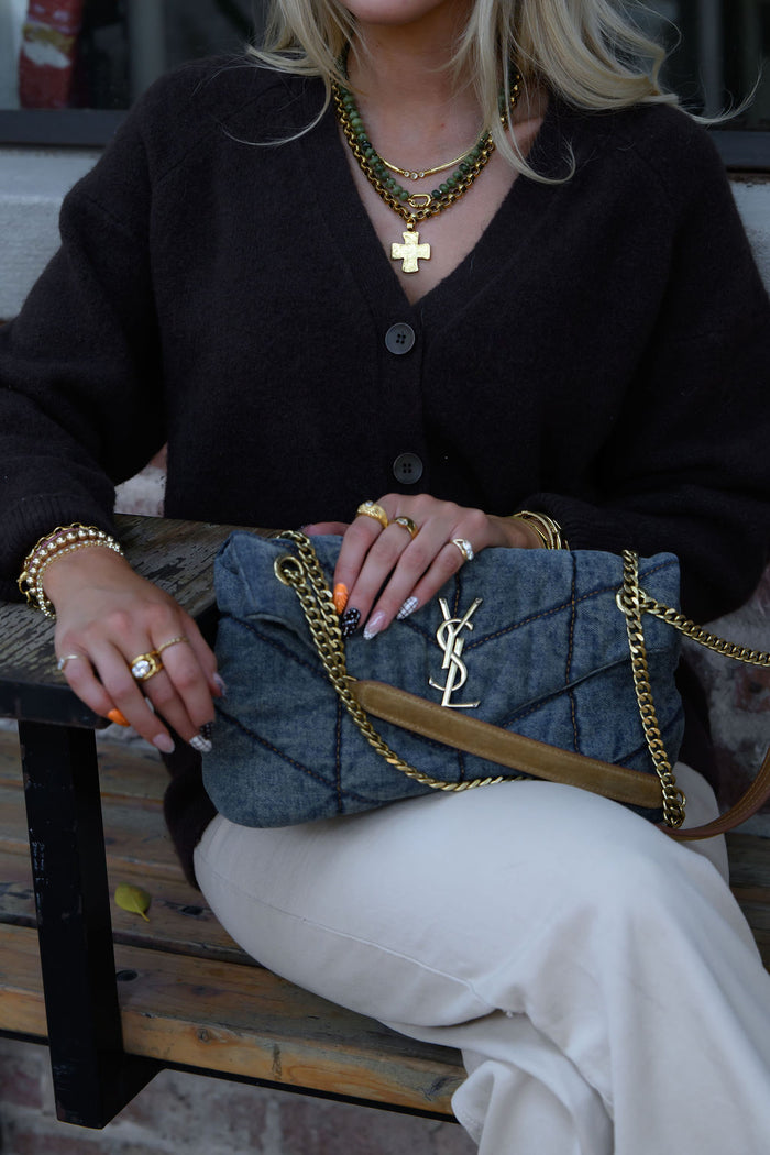 The Kaye necklace pairing bold antique gold links with an old-world cross