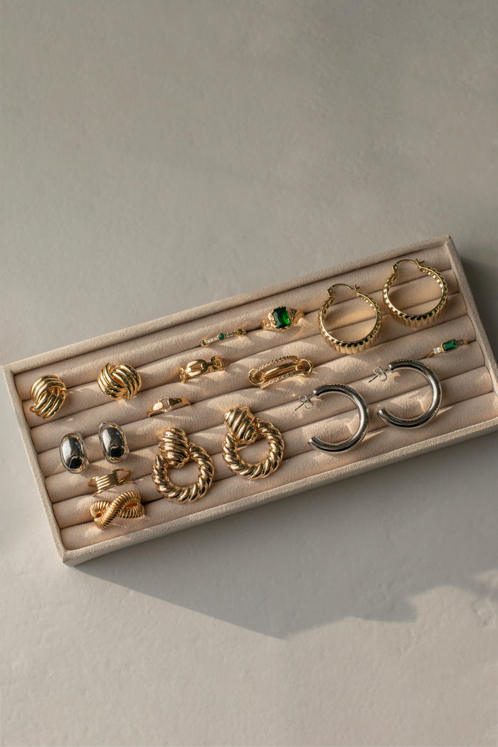 Assorted earrings in a jewelry tray
