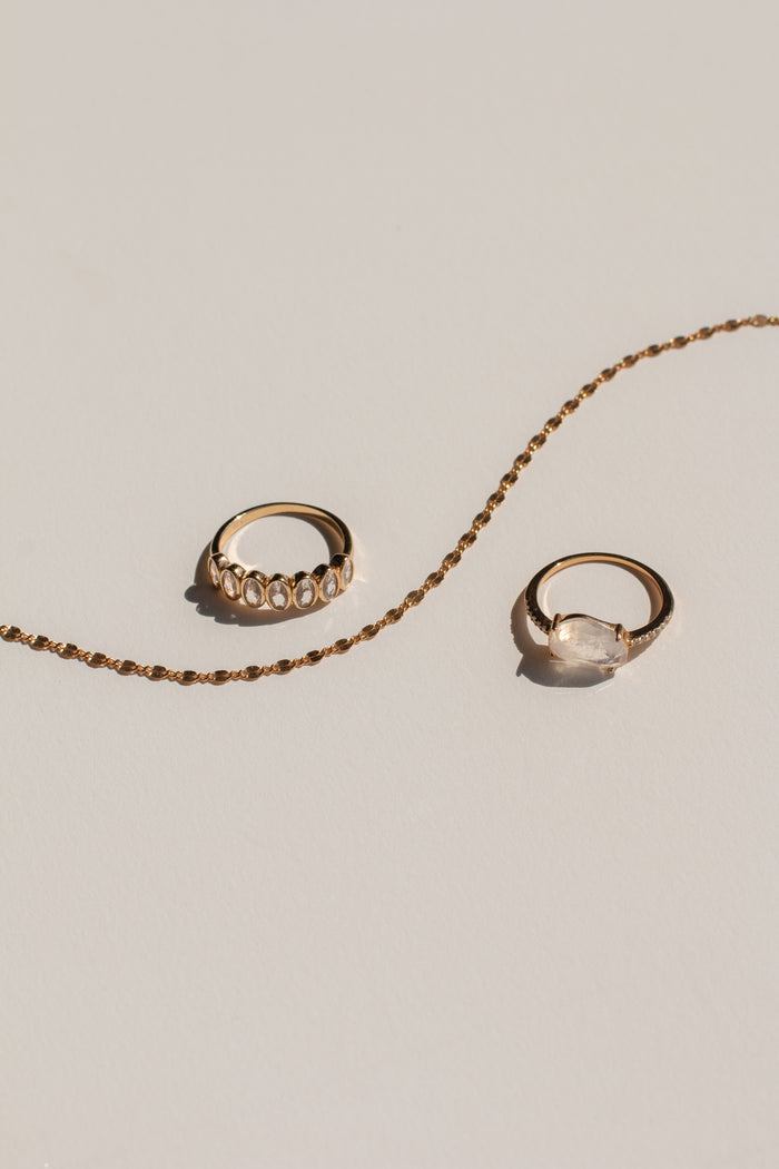Lainie ring detail showing the smooth band and crushed-ice oval stone setting