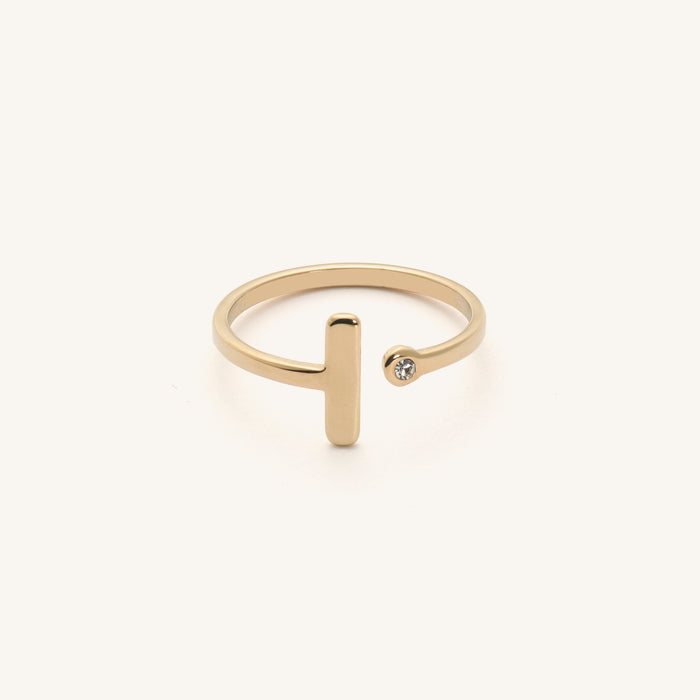 Close up of a hand wearing the gold Lana wrap-around bar ring