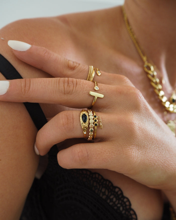 Gold Lana wrap-around bar ring set with sparkling pave CZ stones