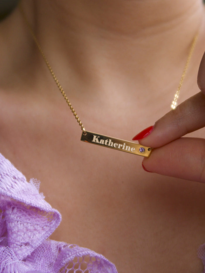 Slim engravable bar necklace set with a micro-pave birthstone in gold