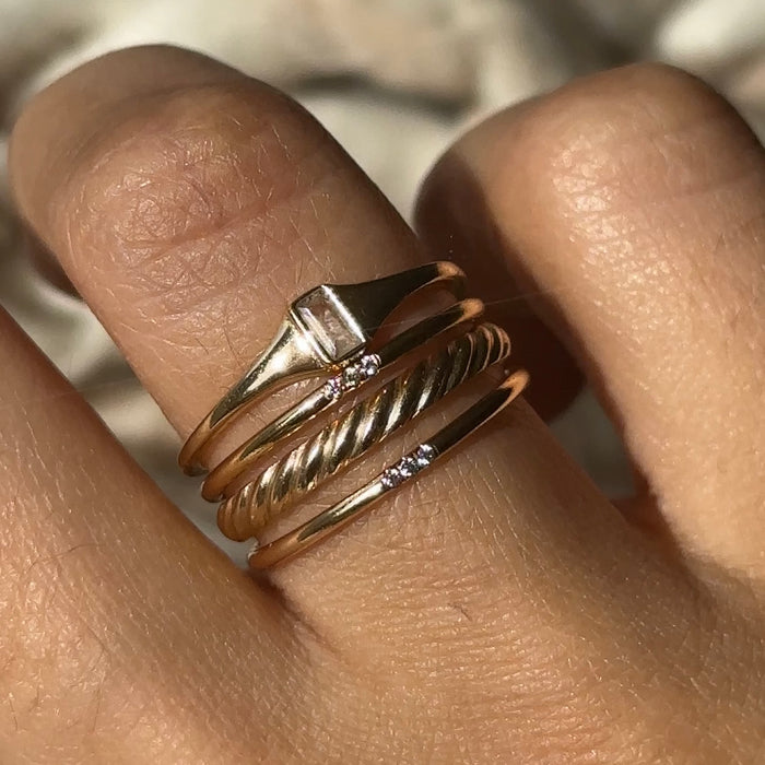 Thin gold signet ring set with a bezel topaz, made for stacking