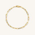 Close up of a gold link bracelet on a white background