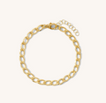Close up of a gold bracelet on a white backgound