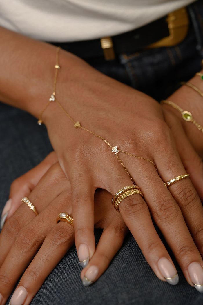 Close up of hands with gold rings and bracelets