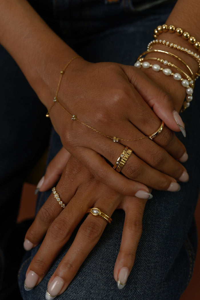 Close up of hands with gold rings and bracelets