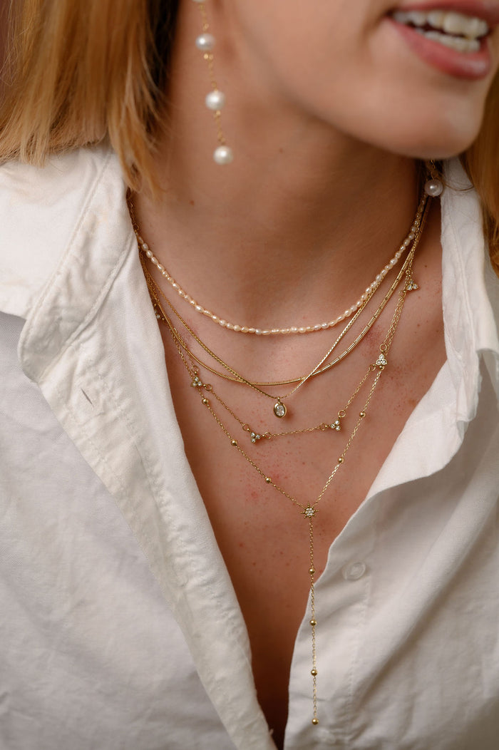 Close up of the gold Lotus cluster necklace by Beads by Tara on a white background