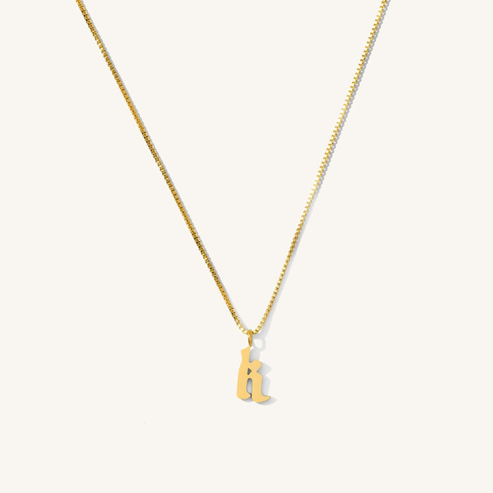 Close up of the Love Letters initial necklace on a white background