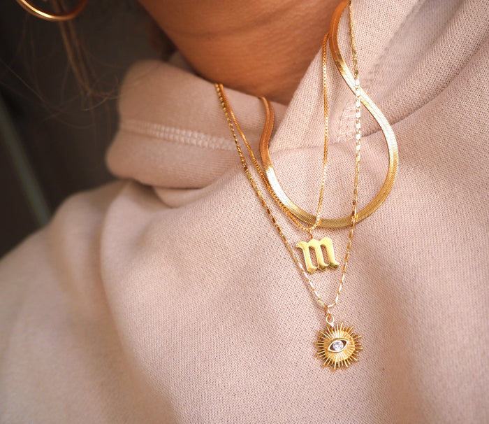 Close up of a neckline wearing the dainty Love Letters initial necklace