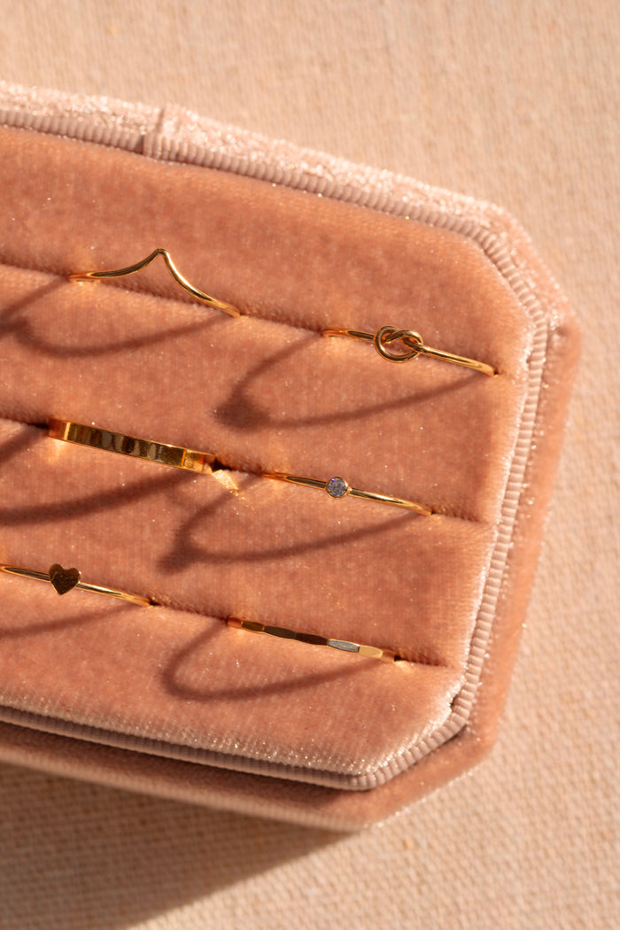 The Love Me ring stacked with other dainty gold-filled bands