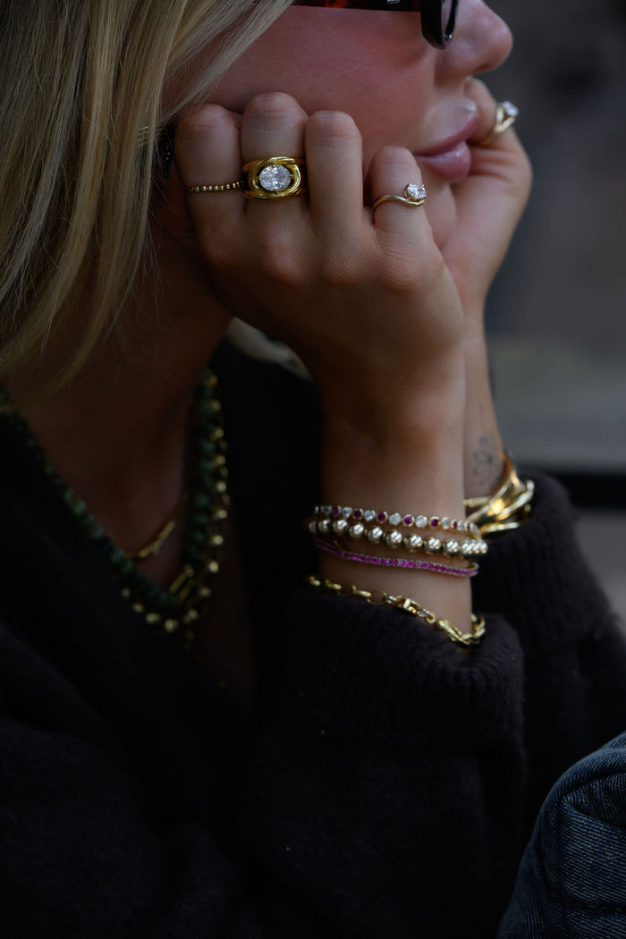 Gold Luma stacking ring, a beaded elastic style that adjusts from 5.5 to 8.5