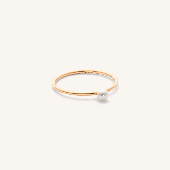 Close up of the gold Maldives pearl ring on a white background