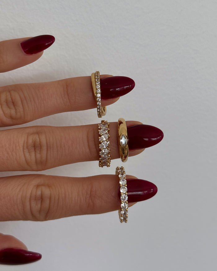 Campaign shot of a model wearing the gold Markie marquise ring