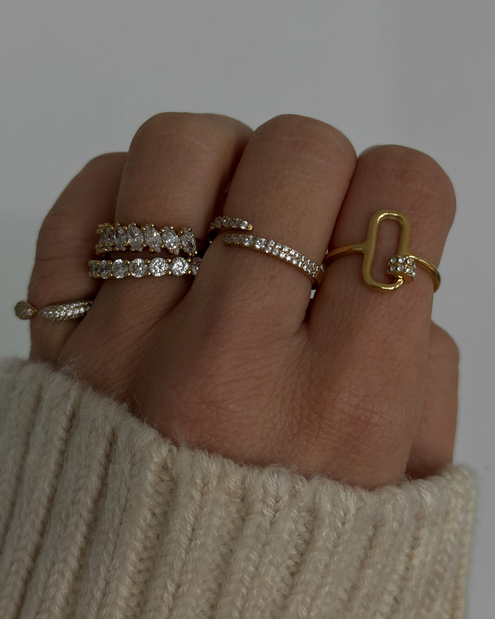 Campaign image of a model wearing the gold Markie marquise ring