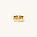 Close up of the gold Marquise cigar band ring on a white background