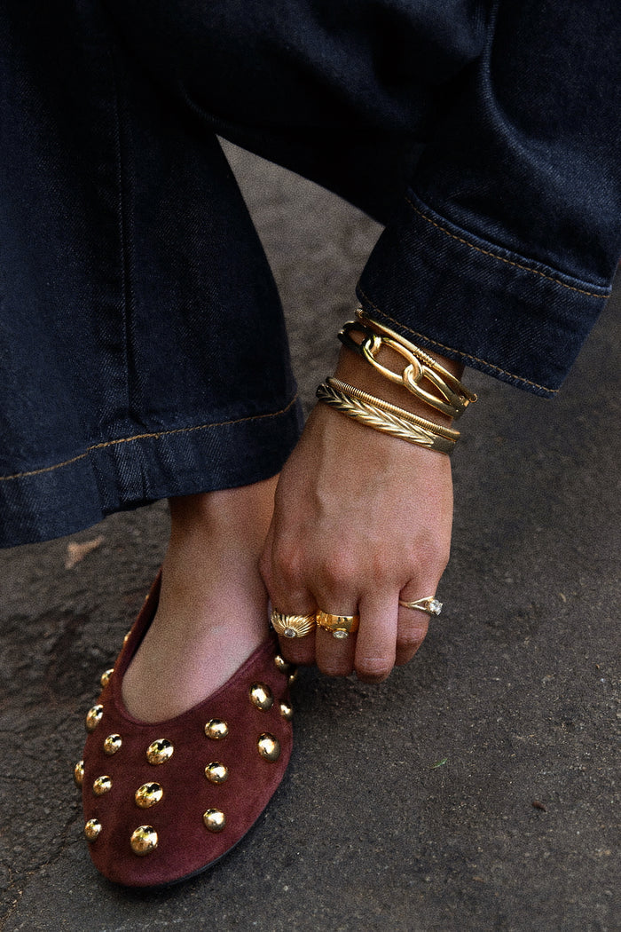 Marquise cigar band ring in gold, a wide silhouette with subtle sparkle