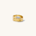 Close up of the gold Marquise Coil ring on a white background