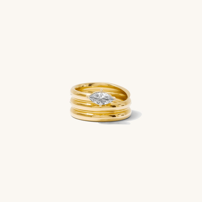 Close up of the gold Marquise Coil ring on a white background