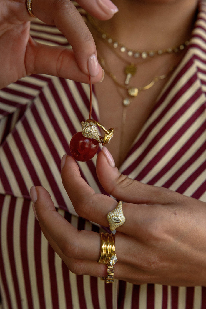 Statement gold ring with a marquise cut stone set between coiled bands