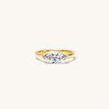 Close up of the gold Marquise pinky ring on a white background