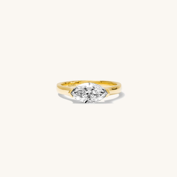 Close up of the gold Marquise pinky ring on a white background