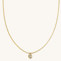 Close up of the gold Martina herringbone necklace on a white background