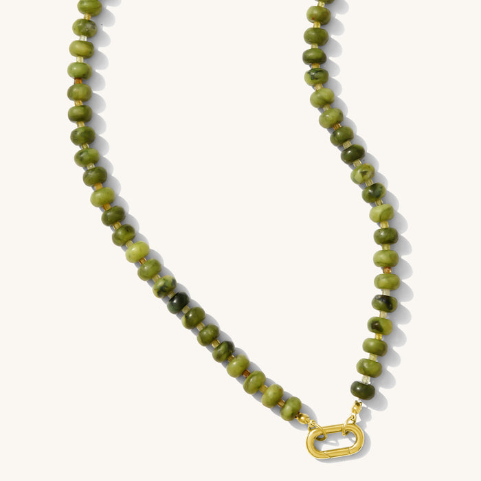 The Matcha necklace strung with warm green agate quartz and a gold carabiner clasp