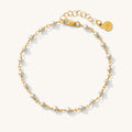 Close up of the Maui pearl and gold bracelet on a white background