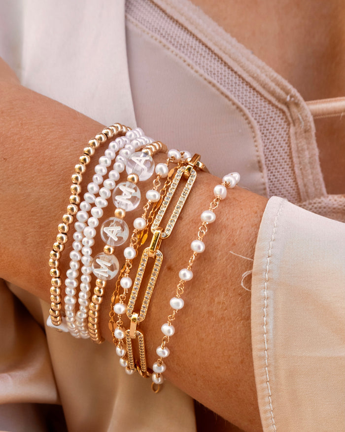 Maui pearl bracelet layered with a clear letter custom name bracelet