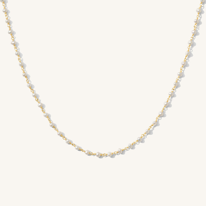 Close up of the gold Maui pearl necklace on a white background