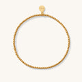 Close up of a gold mini bead bracelet
