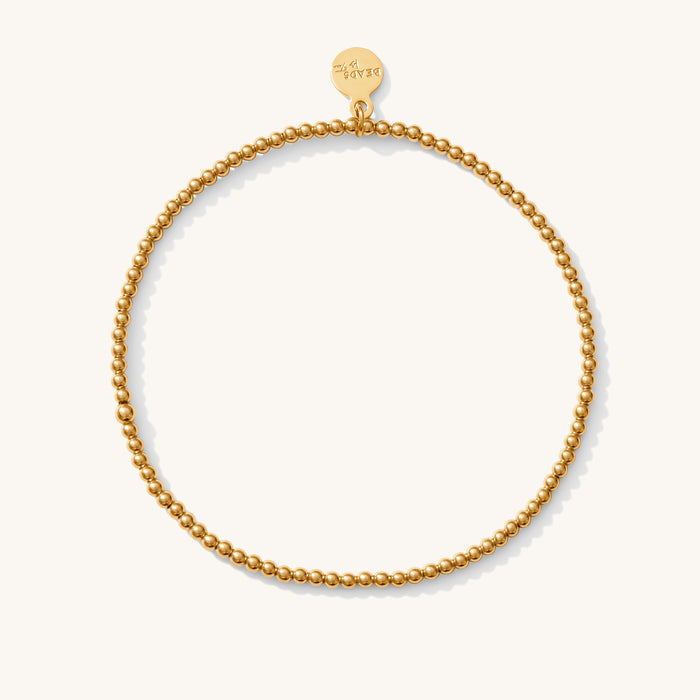 Close up of a gold mini bead bracelet