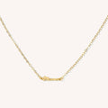 Close up of the gold mini mama necklace on a white background